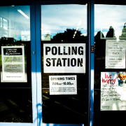 polling station poster on clear glass door